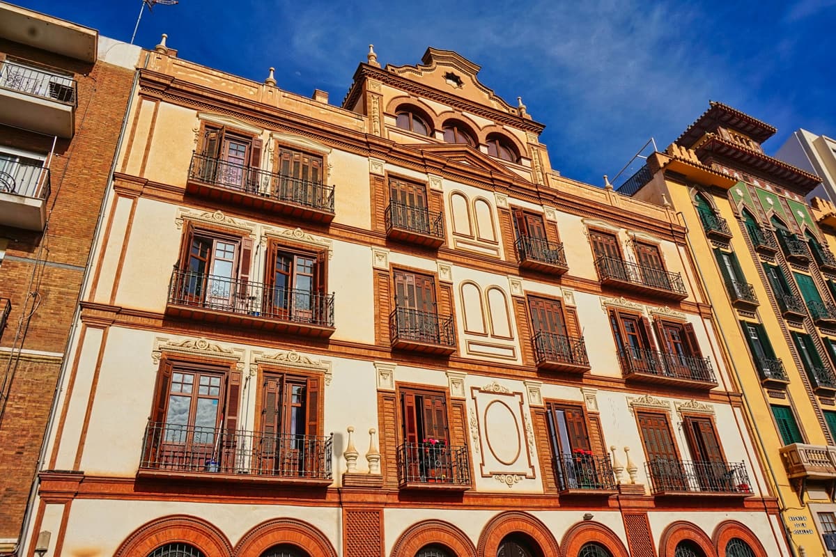 The Renaissance courtyard of the Palacio de Buenavista, home of the Museo Picasso Málaga — stone columns and wooden galleries around a sunlit patio in the historic centre of Málaga, Spain.